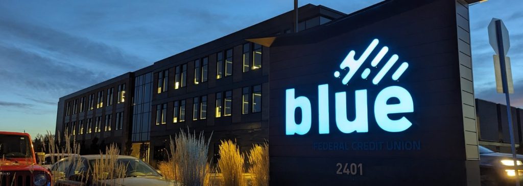 Blue HQ Sign at dusk. Annual Meeting hero image.